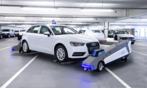 A Ray robot, made by Serva Transport Systems, picks up and moves an Audi car at its Ingolstadt plant