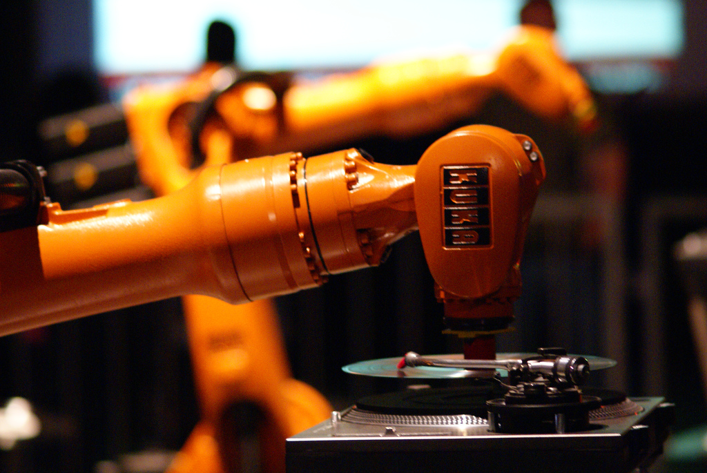 industrial robot playing a vinyl record