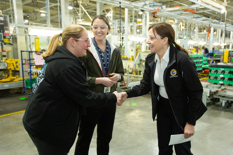 GM CEO Mary Barra talks with employees Angela Jarrett, left, and Kayla Owens at the GM Romulus plant