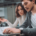 Colleagues from the marketing department discuss AI’s suggested campaign tactic