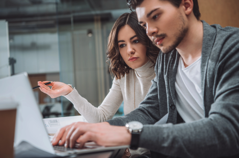 Colleagues from the marketing department discuss AI’s suggested campaign tactic
