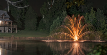Illuminated aeration fountain on a pond.